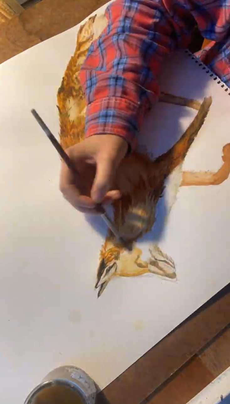 Gretchen painting a fox in watercolor